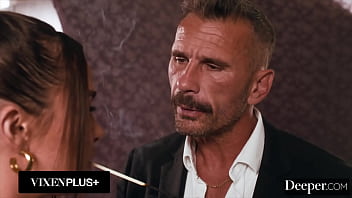 A cigar shop employee is at the service of an exacting customer