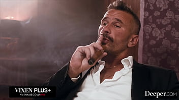 A cigar shop employee is at the service of an exacting customer