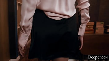 A cigar shop employee is at the service of an exacting customer