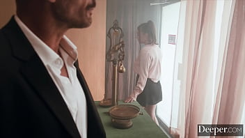 A cigar shop employee is at the service of an exacting customer