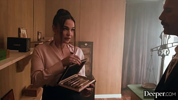 A cigar shop employee is at the service of an exacting customer