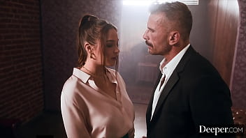 A cigar shop employee is at the service of an exacting customer