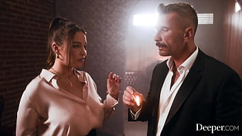 A cigar shop employee is at the service of an exacting customer