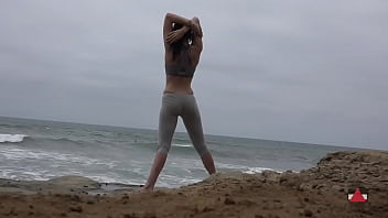 Girl meditates at by the oceans