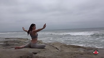 Girl meditates at by the oceans