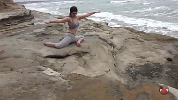 Girl meditates at by the oceans