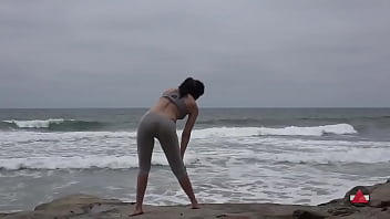 Girl meditates at by the oceans