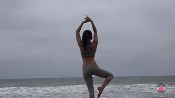 Girl meditates at by the oceans
