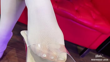 I sit on the couch in sexy white stockings and dangle my heels I sit on the couch in sexy white stockings and dangle my heels