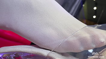 I sit on the couch in sexy white stockings and dangle my heels