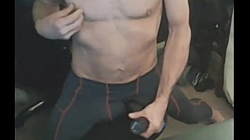 Stretching in spandex on stool with massage gun