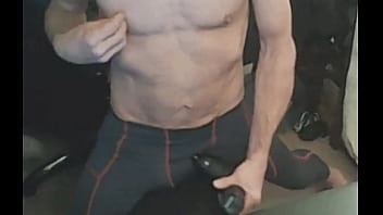 Stretching in spandex on stool with massage gun