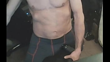 Stretching in spandex on stool with massage gun