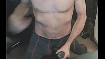 Stretching in spandex on stool with massage gun