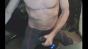 Stretching in spandex on stool with massage gun