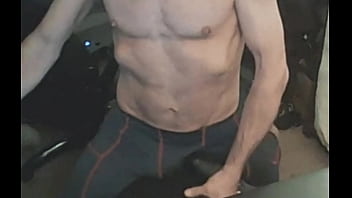 Stretching in spandex on stool with massage gun