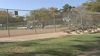 The two blonde teens are sitting on the couch with their soccer coach who happens to be a