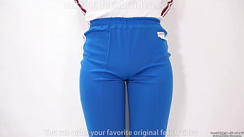 Girl pulls trousers down with her hands and digs them into her crotch