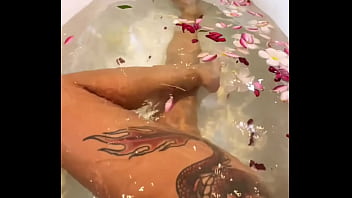 Horny busty milf in flower bath plays with her pussy