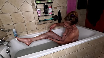 Stripping out of red dress to shave my skinny legs and yummy pussy while enjoying a soapy bath