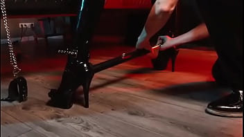 Spread your legs pleaser heels with rubber toe socks and a full black catsuit caught in a spreader bar ready to be used