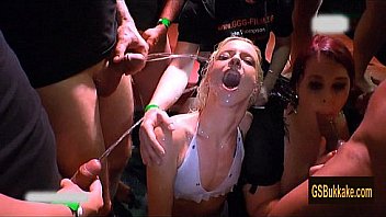 Amateur girls blow while being pissed on by a group of cocks