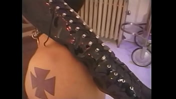 Busty chick with long red hair spanks tied up tattooed guy's ass