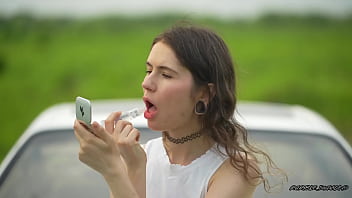 Messy pink lipgloss marks on the car window