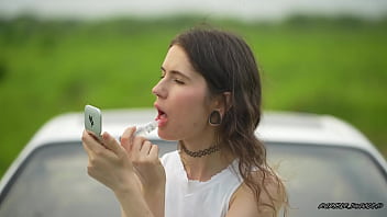 Messy pink lipgloss marks on the car window