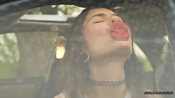 Messy pink lipgloss marks on the car window