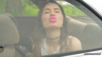 Messy pink lipgloss marks on the car window
