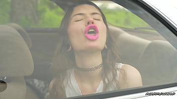 Messy pink lipgloss marks on the car window