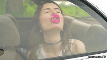 Messy pink lipgloss marks on the car window