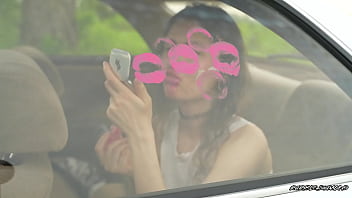 Messy pink lipgloss marks on the car window