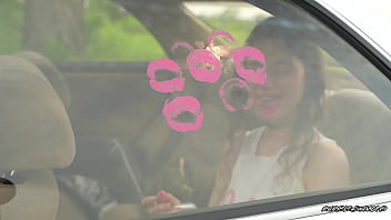 Messy pink lipgloss marks on the car window