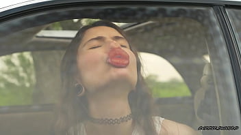 Messy pink lipgloss marks on the car window