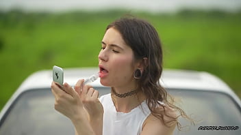 Messy pink lipgloss marks on the car window