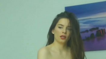 Smug brunette smokes a cigarette in front of the camera Smug brunette smokes a cigarette in front of the camera