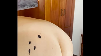 Hot wax is dripping onto my ass