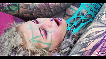 Tattooed babe straps on a huge toy for the slutty girl