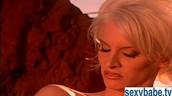 Blonde at the beach with big titties