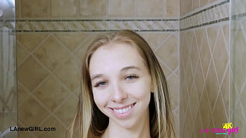 Fresh faced blonde model enjoys a sensual bath