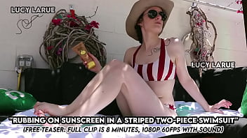 Rubbing on sunscreen in a striped two piece swimsuit Rubbing on sunscreen in a striped two piece swimsuit