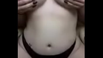 Busty burnette plays with her tits