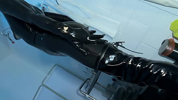 Solo 1 showcasing studio black latex catsuit and huge red cobra strap on