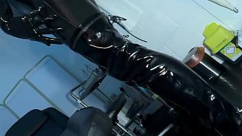 Solo 1 showcasing studio black latex catsuit and huge red cobra strap on