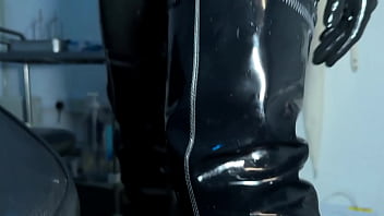 Solo 1 showcasing studio black latex catsuit and huge red cobra strap on