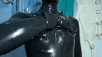 Solo 1 showcasing studio black latex catsuit and huge red cobra strap on