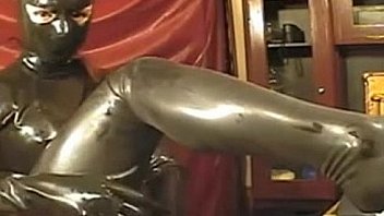 Girl in latex tight dress and mask on webcam