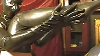 Girl in latex tight dress and mask on webcam